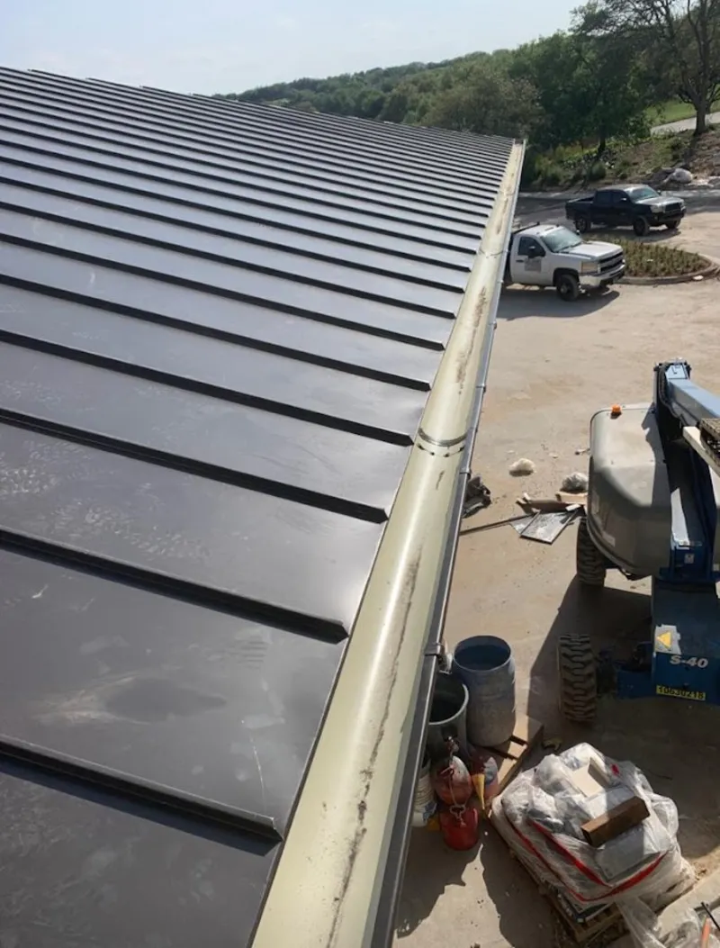 Standing seam panel and gutter detail on a metal roofing jobsite in Portland